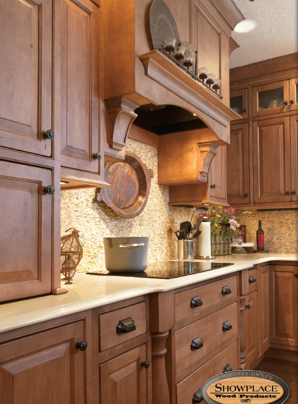 A kitchen with wooden cabinets and granite counter tops.