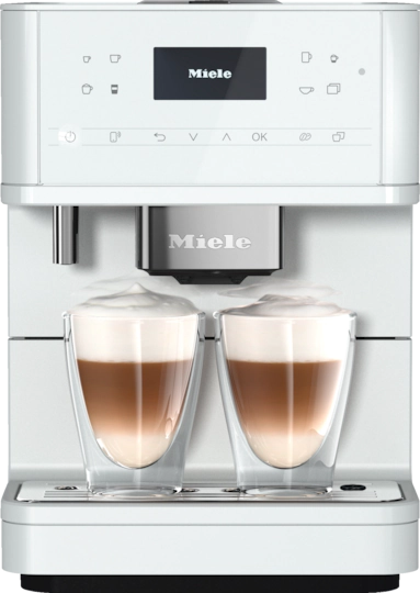 A white coffee machine with two cups of coffee.