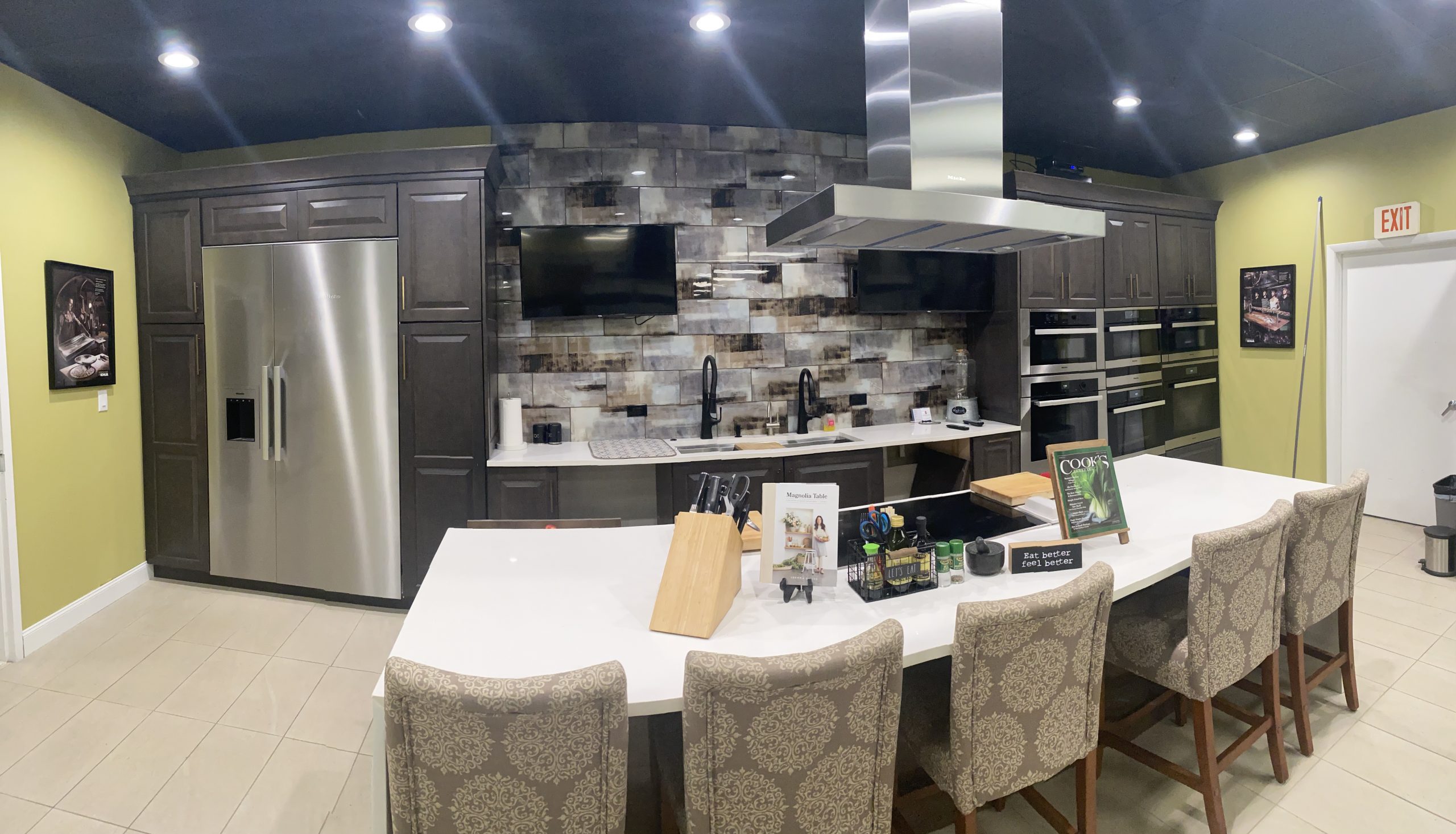 A kitchen with a large island and stainless steel appliances.